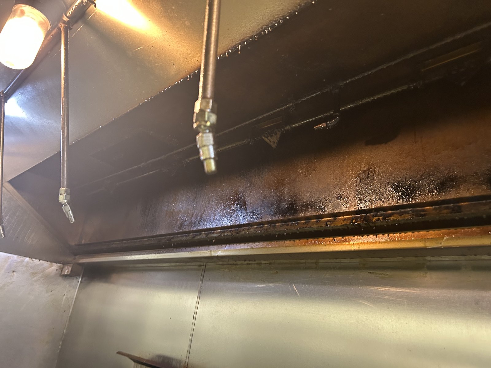 Kitchen hood with grease buildup on the underside